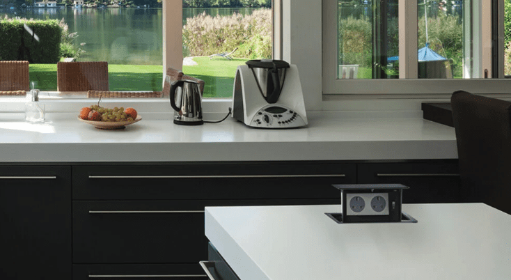 Modern kitchen with white countertop outlets installed by electrician reno